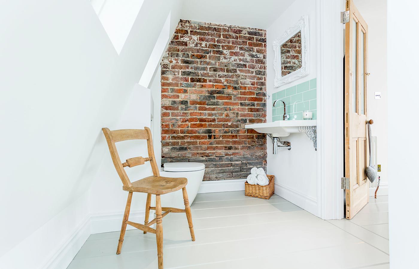 En-suite bathroom in Old Portsmouth with exposed brick wall by Westcott Construction