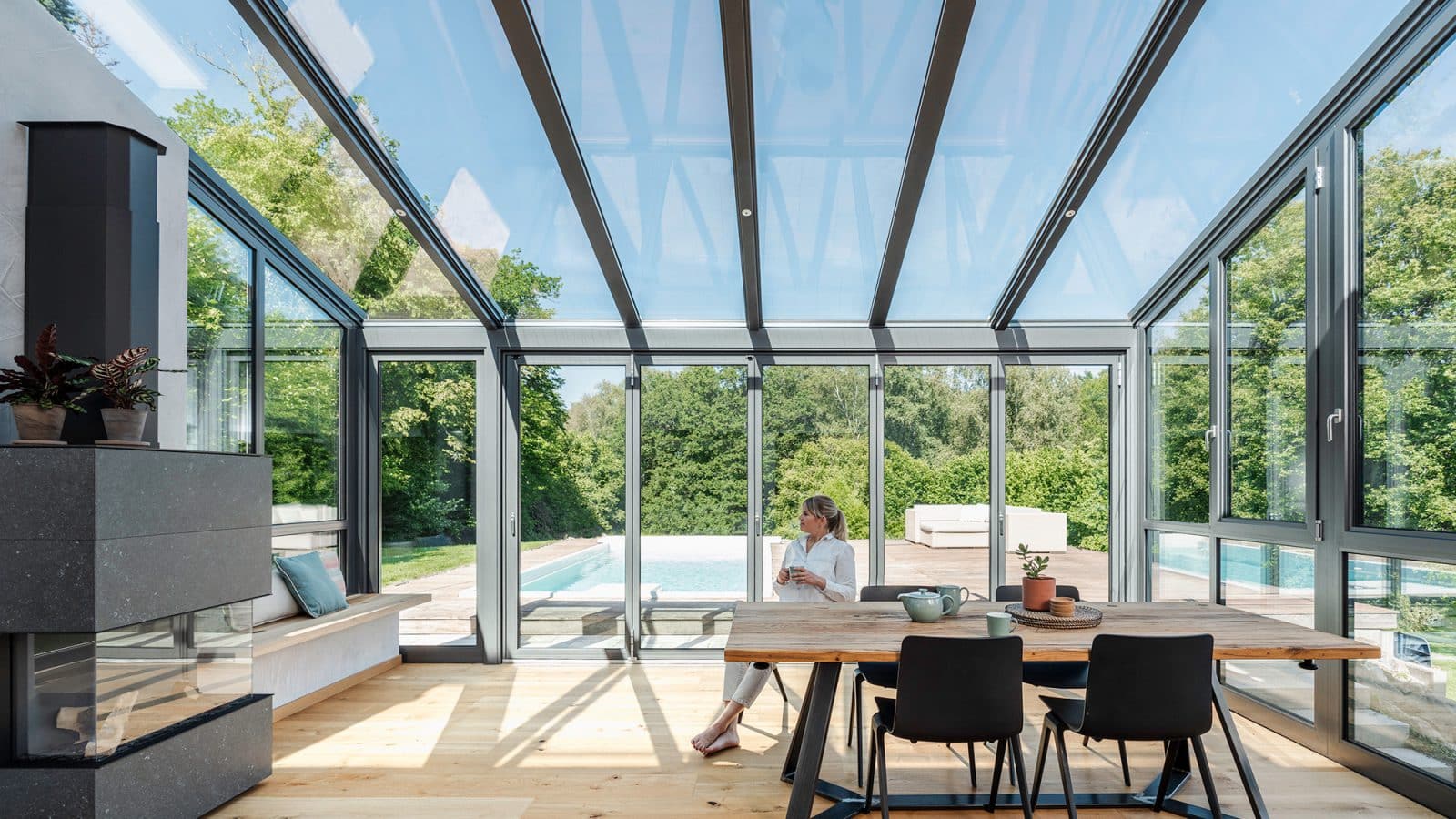 A woman enjoying a drink in her home.