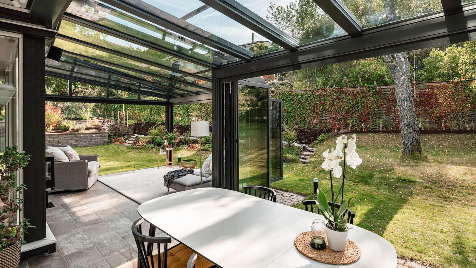 The inside of a glazed extension looking out into the garden.