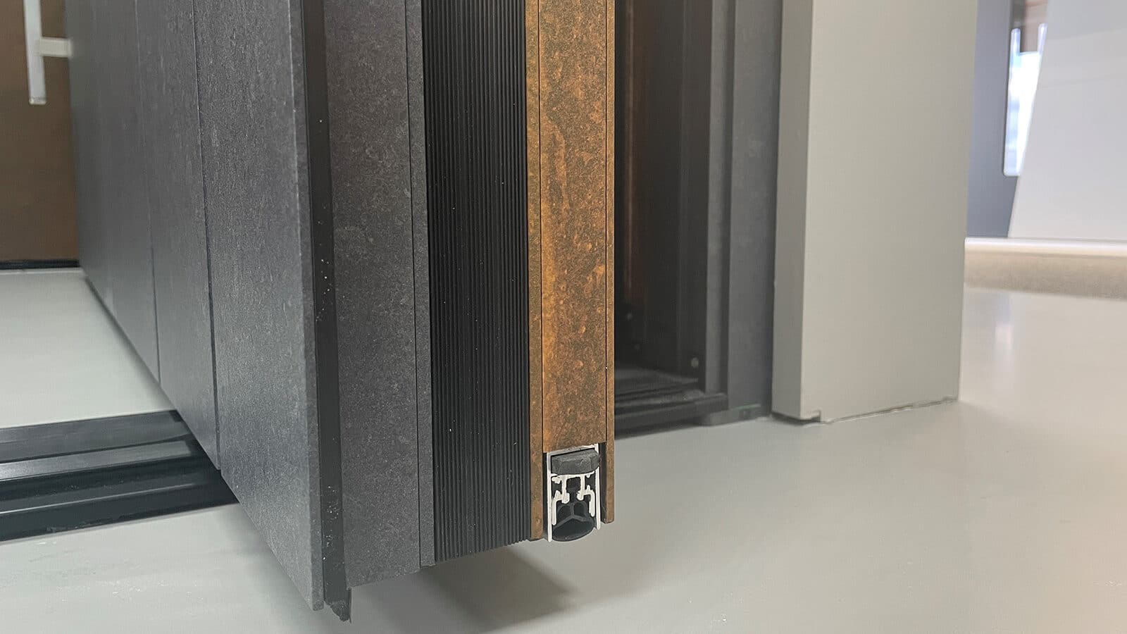 Close-up view of the Spitfire S-700 pivot door weather seal showing its high-performance sealing system for enhanced insulation and protection